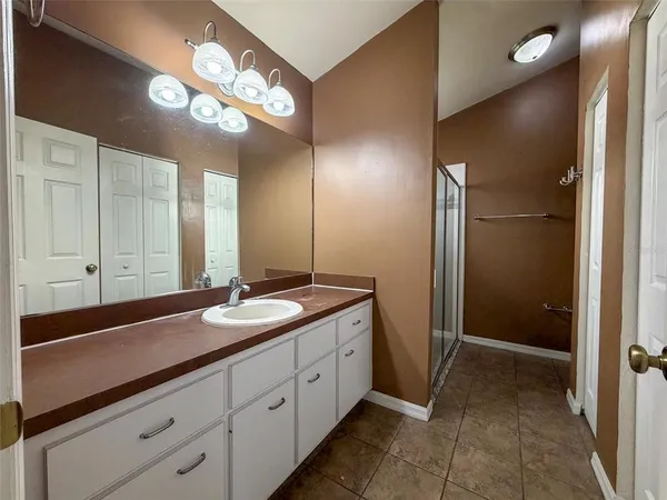 a spacious bathroom with a double vanity sink and a mirror