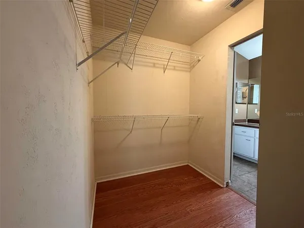 a view of a room with wooden floor