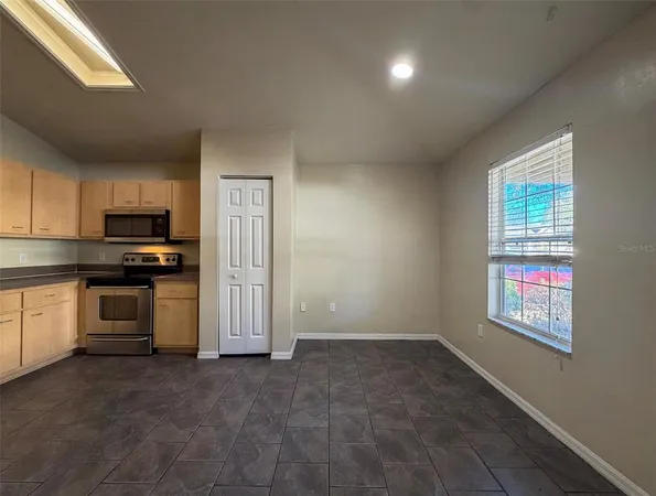 a kitchen with a refrigerator and window