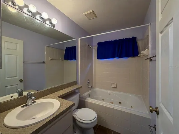 a bathroom with a sink a toilet and a bathtub