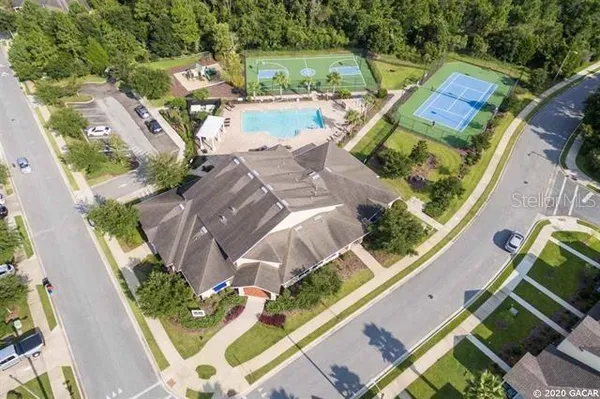 an aerial view of a house with a garden and lake view