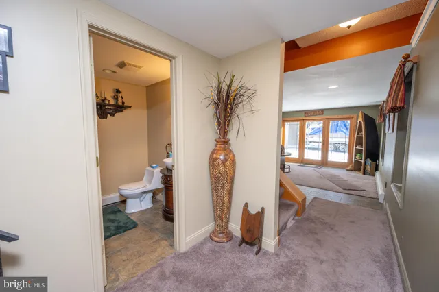 a bathroom with a granite countertop toilet sink and mirror