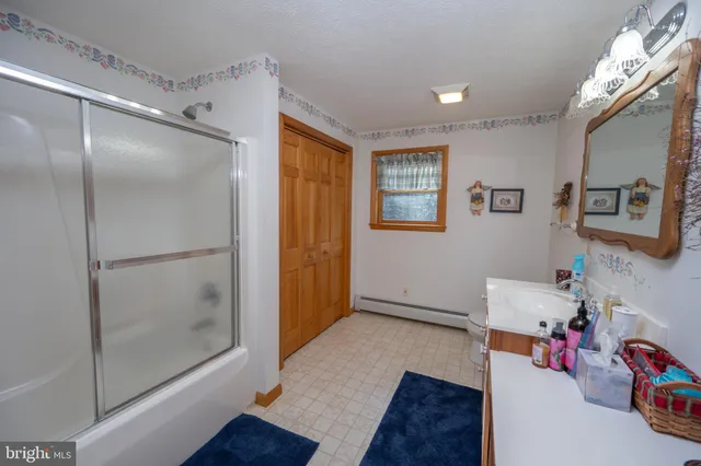 a bedroom with furniture and a rug