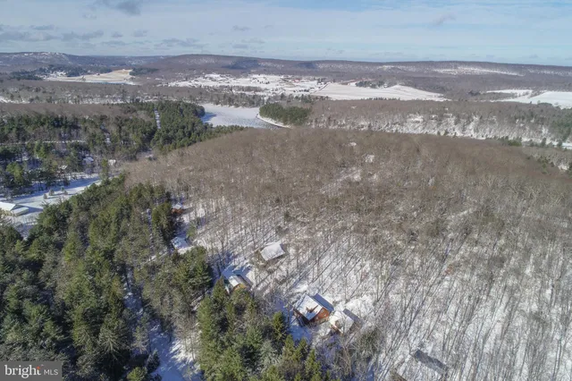 a view of a patio with fire pit and chairs