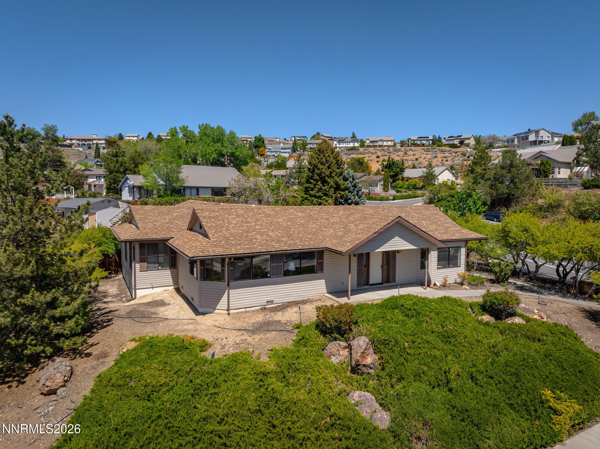 2985 Socrates Drive Reno, NV 89512 - Photo 2 of 52 a view of a house with a big yard plants and large trees