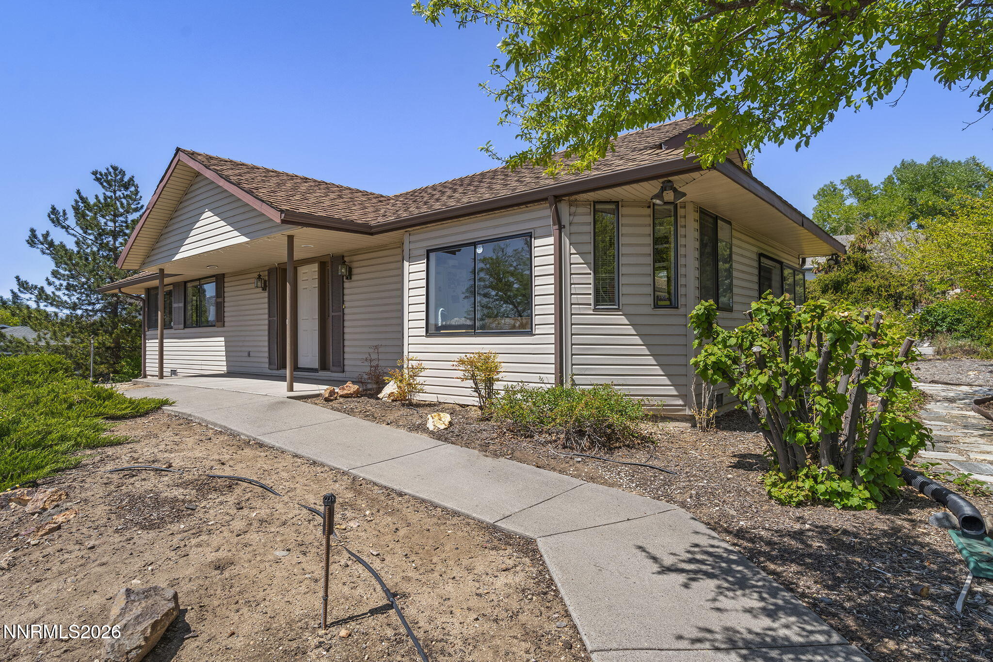 2985 Socrates Drive Reno, NV 89512 - Photo 23 of 52 a front view of a house with garden