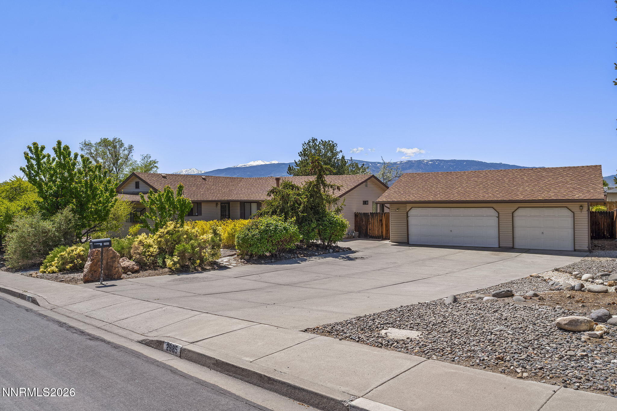 2985 Socrates Drive Reno, NV 89512 - Photo 25 of 52 a front view of a house with a yard and garage
