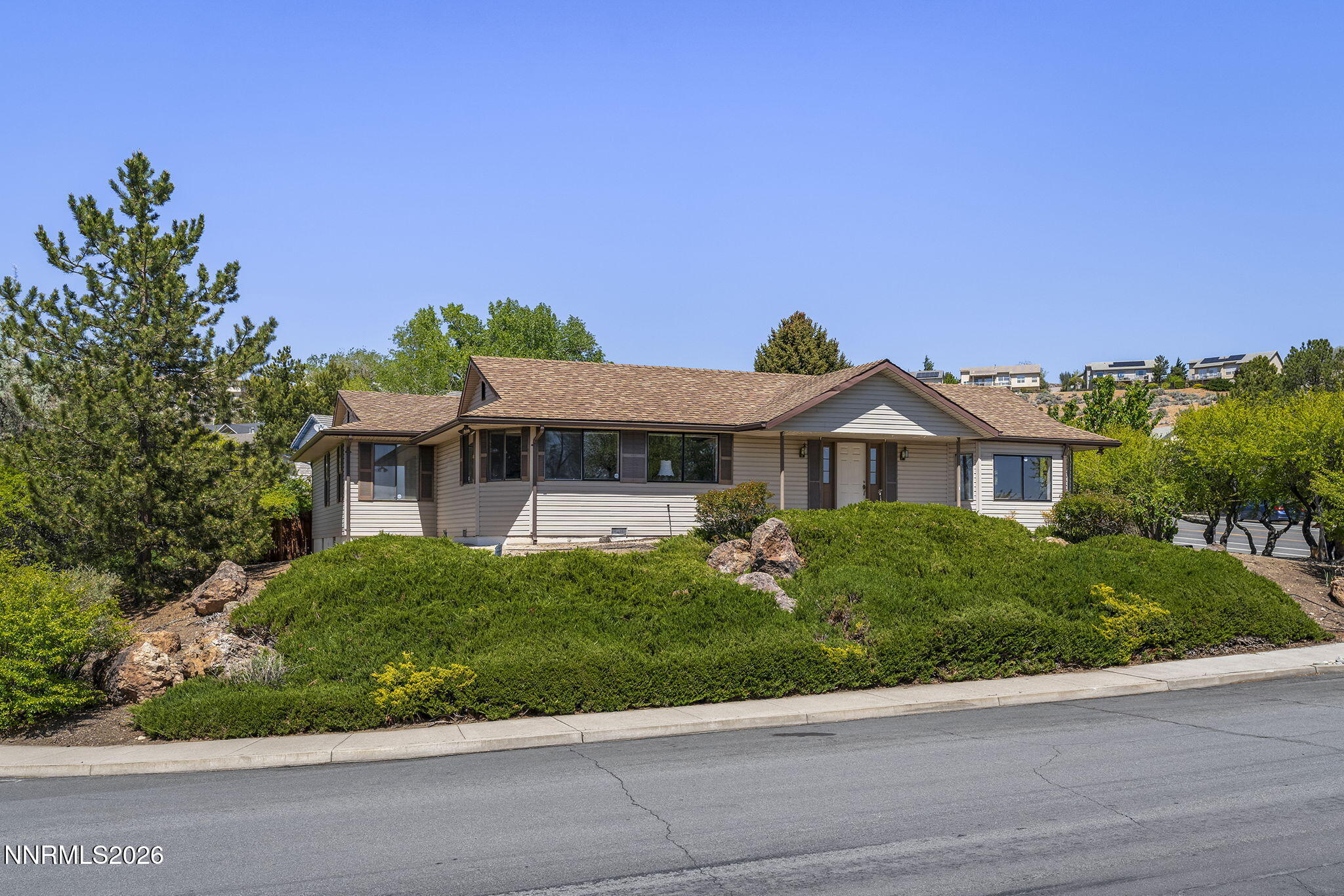 2985 Socrates Drive Reno, NV 89512 - Photo 5 of 52 a front view of a house with a yard and potted plants