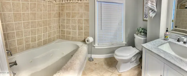 a white bath tub sitting next to a white toilet