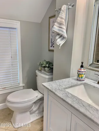 a white toilet sitting next to a bathroom sink