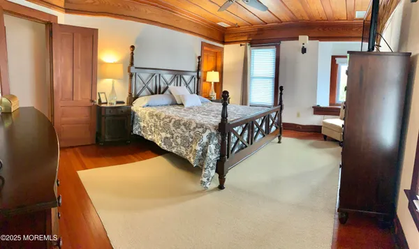 a bedroom with furniture and a large window