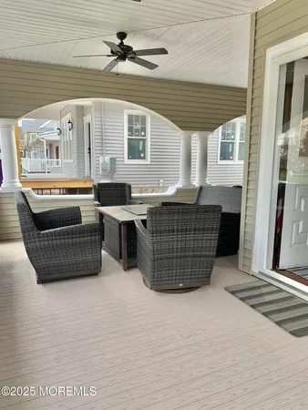 a living room with furniture a flat screen tv and kitchen view