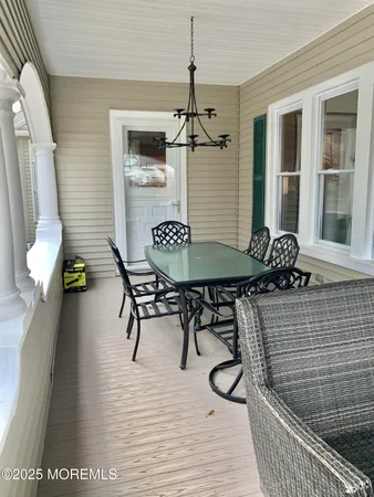a dining room with furniture and wooden floor
