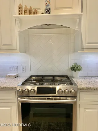 a stove top oven sitting inside of a kitchen