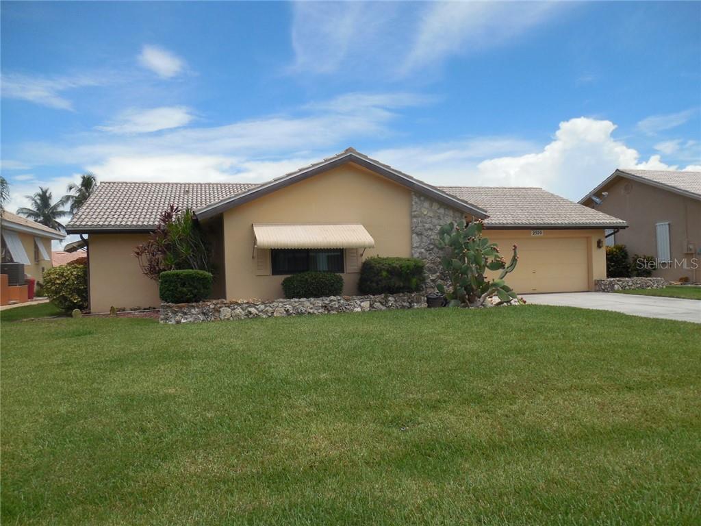 2520 Rio Largo Court Punta Gorda, FL 33950 - Photo 1 of 1 a front view of a house with a garden