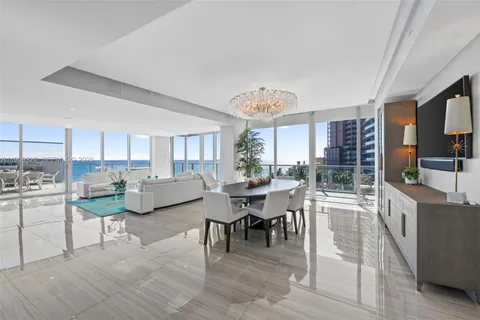 a view of a patio with a dining table and chairs with wooden floor