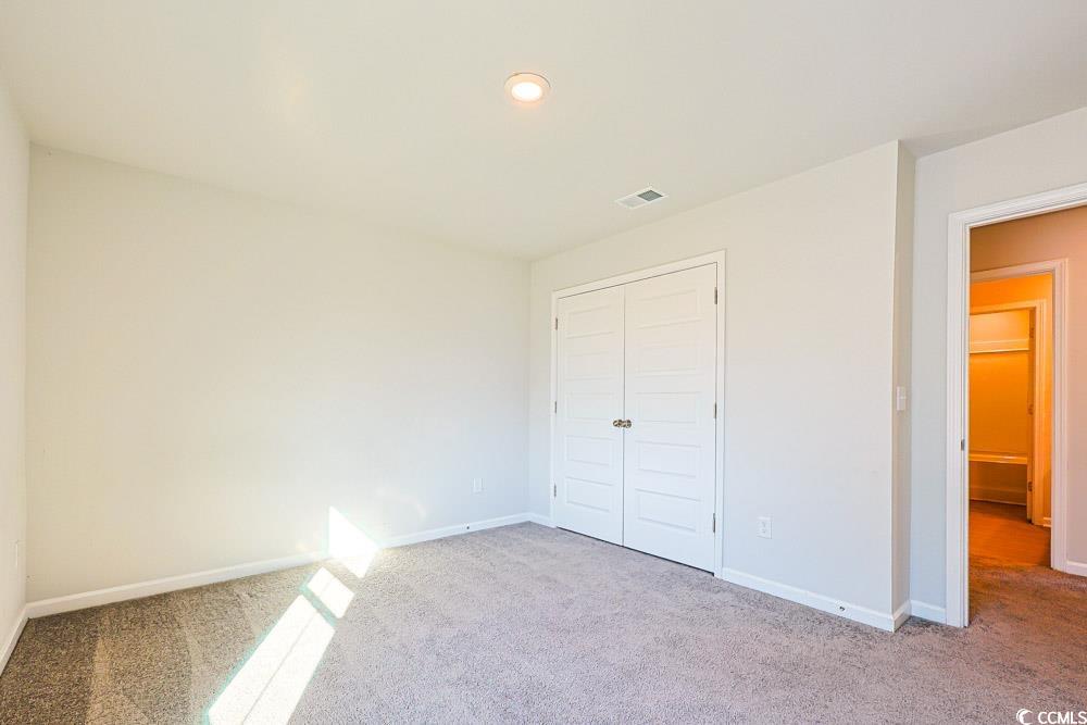 1560 Swing Bridge Way Myrtle Beach, SC 29588 - Photo 24 of 35 Unfurnished bedroom with carpet, a closet, and recessed lighting