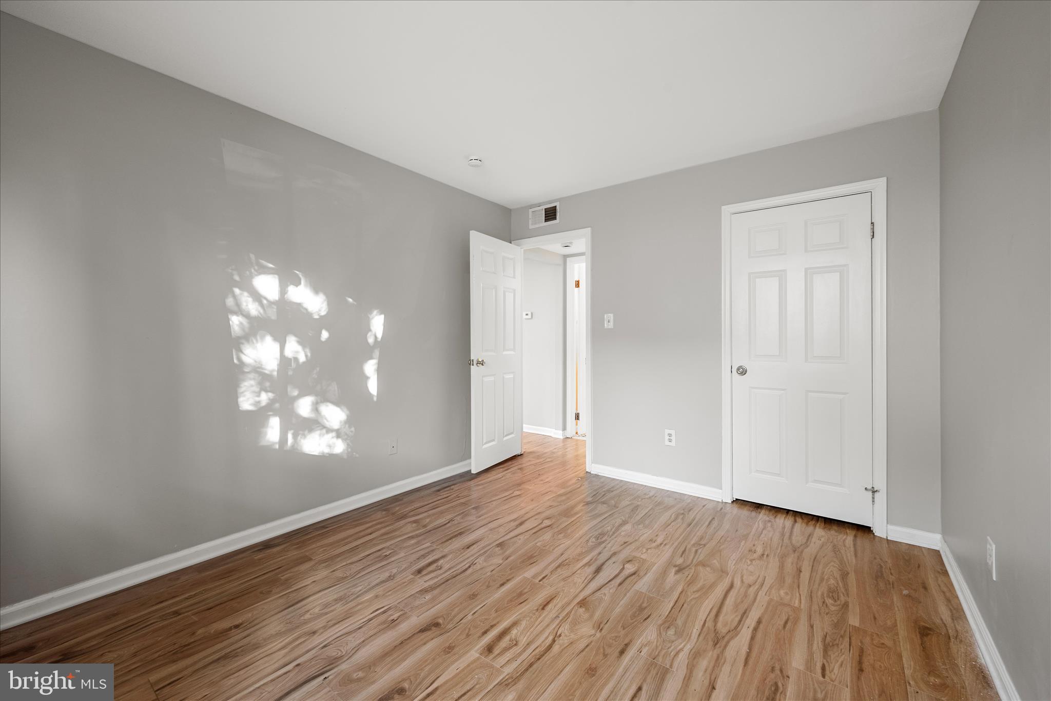 156 Haycock Road, Unit A6 Falls Church, VA 22046 - Photo 29 of 30 a view of an empty room with wooden floor and a window