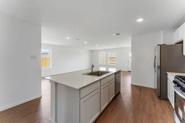 a kitchen with a sink stove and refrigerator