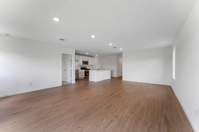 a view of kitchen and hall with wooden floor