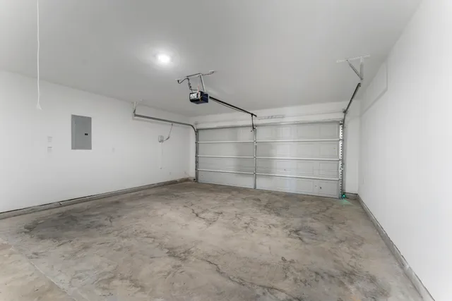 a view of a yard in front of a house with a large tree