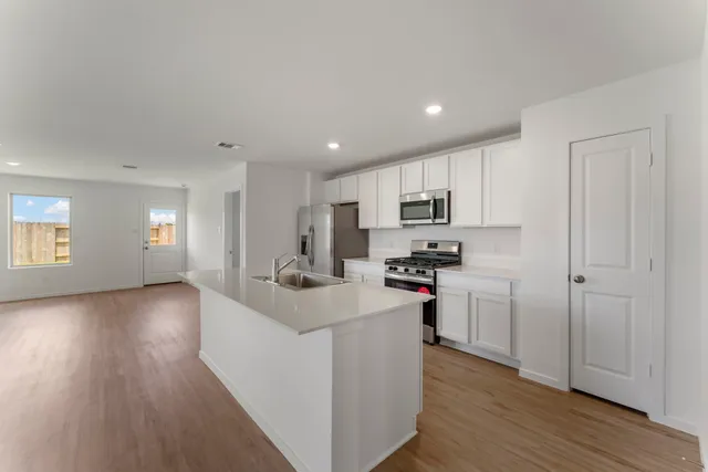 a view of a kitchen cabinets and wooden floor