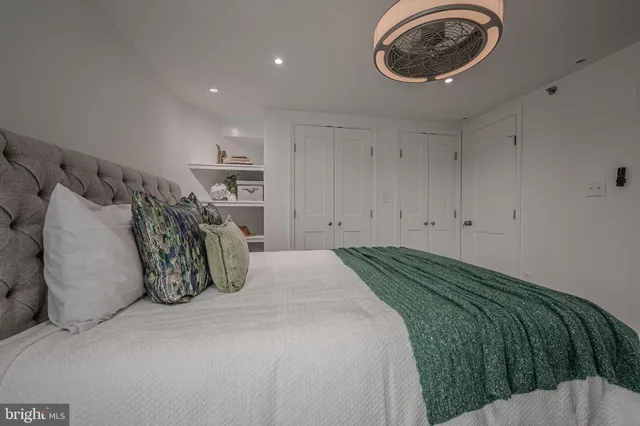 a bedroom with a bed and a lamp