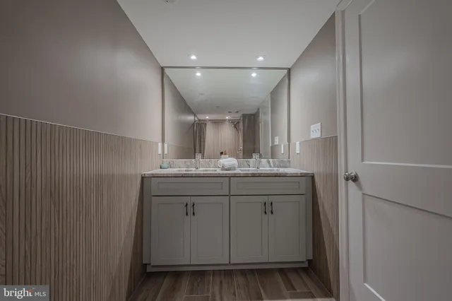 a bathroom with a sink vanity and mirror