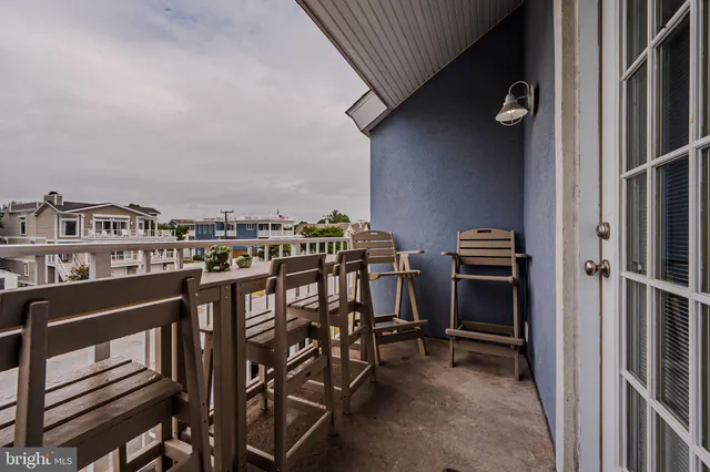 a view of a chairs and table in a balcony