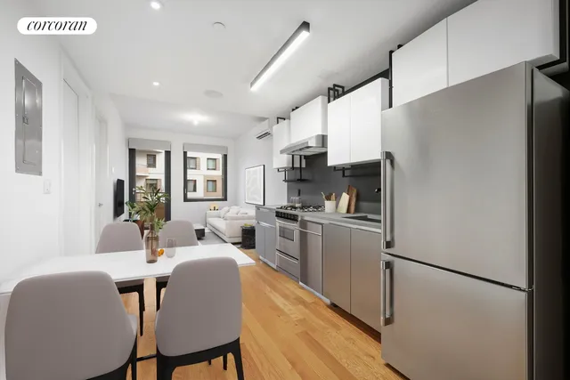 a living room with furniture and kitchen view
