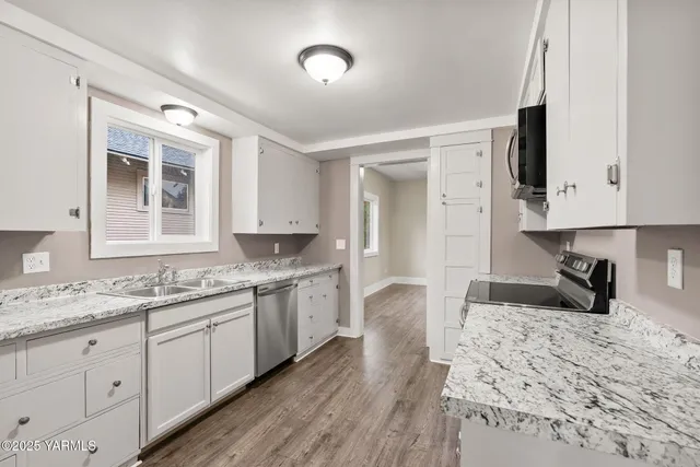 a kitchen with a sink stove and cabinets