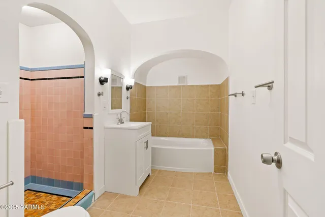 a bathroom with a bathtub and shower