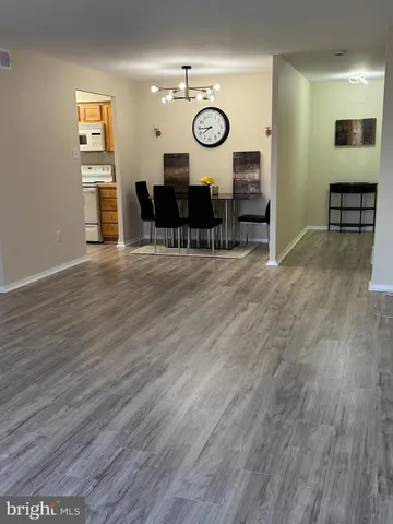 a view of a room with wooden floor