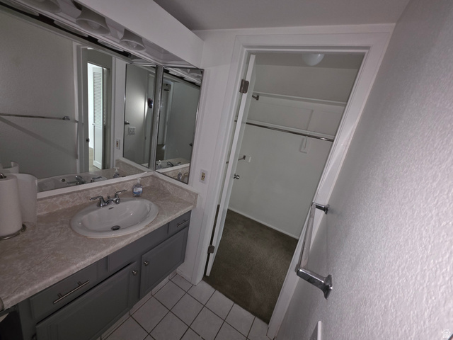 6852 Countrywoods Circle, Unit 5D Midvale, UT 84047 - Photo 26 of 50 Bathroom vanity featuring a single basin, grey cabinetry, and a light-toned countertop