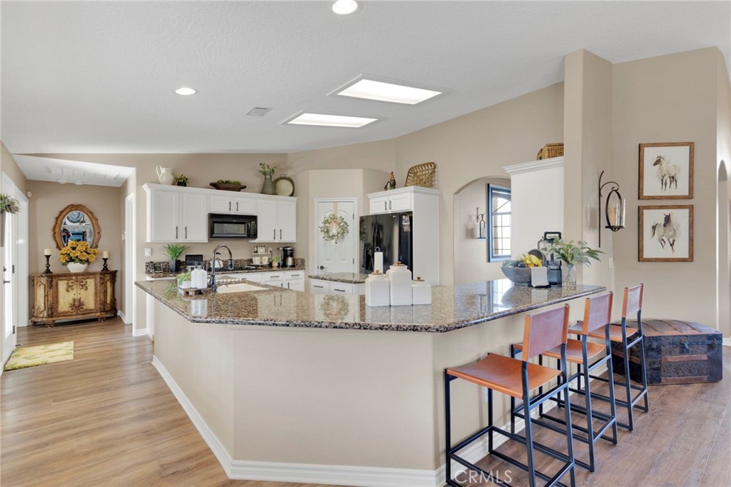 2909 Silver Ridge Drive Pinon Hills, CA 92372 - Photo 11 of 55 a kitchen with kitchen island granite countertop lots of counter top space and stainless steel appliances