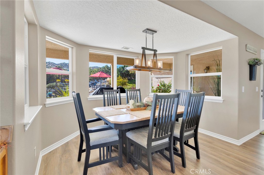 2909 Silver Ridge Drive Pinon Hills, CA 92372 - Photo 12 of 55 a view of a dining room with furniture window and wooden floor