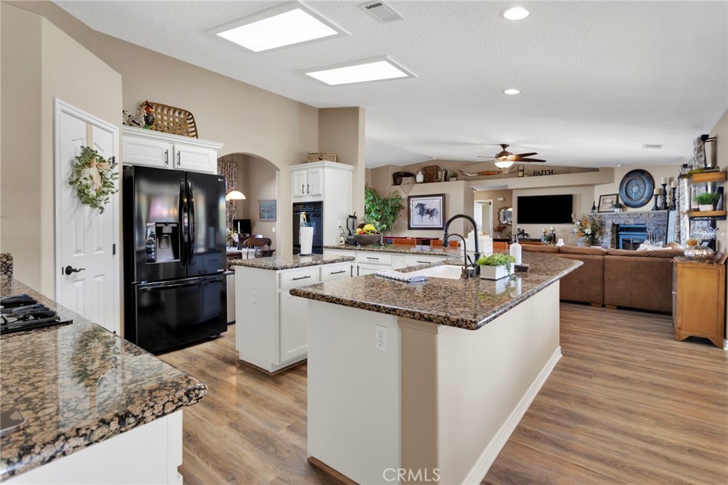 2909 Silver Ridge Drive Pinon Hills, CA 92372 - Photo 14 of 55 a kitchen with stainless steel appliances kitchen island granite countertop a sink and cabinets