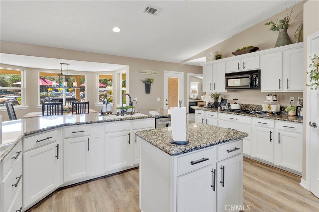 2909 Silver Ridge Drive Pinon Hills, CA 92372 - Photo 16 of 55 a kitchen with stainless steel appliances granite countertop a sink dishwasher and cabinets with wooden floor
