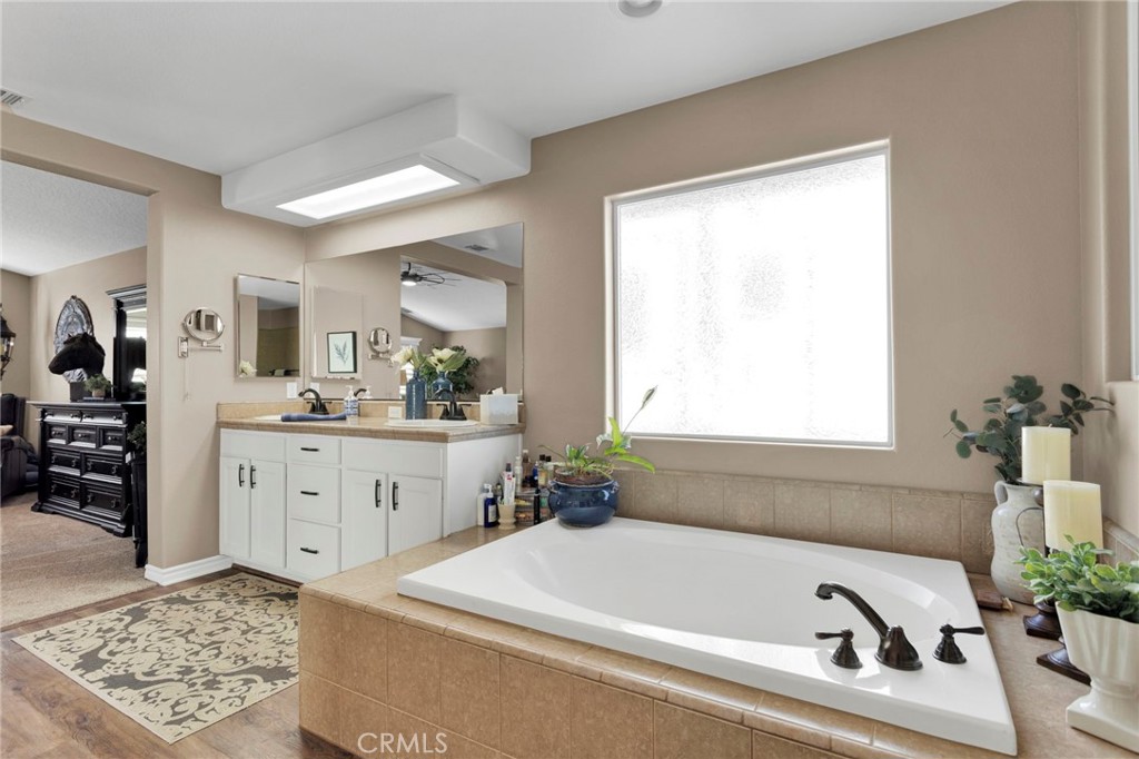 2909 Silver Ridge Drive Pinon Hills, CA 92372 - Photo 24 of 55 a bathroom with a bathtub sink and a window
