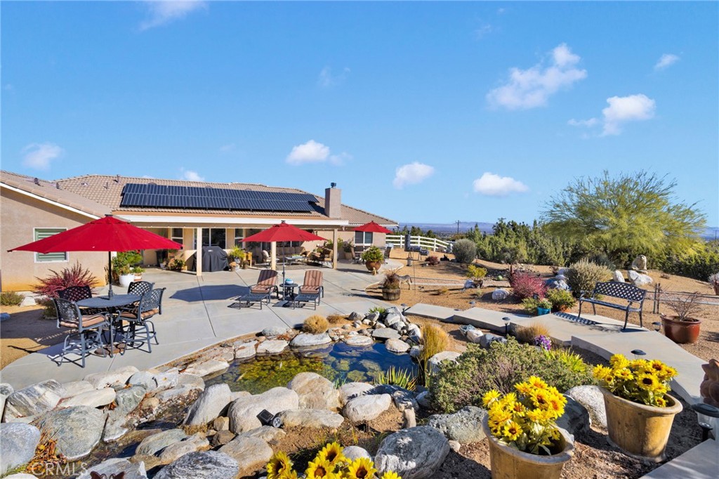2909 Silver Ridge Drive Pinon Hills, CA 92372 - Photo 37 of 55 an outdoor space with patio lots of furniture and umbrella