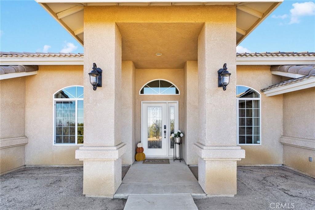 2909 Silver Ridge Drive Pinon Hills, CA 92372 - Photo 4 of 55 a view of a brick house with a potted plant