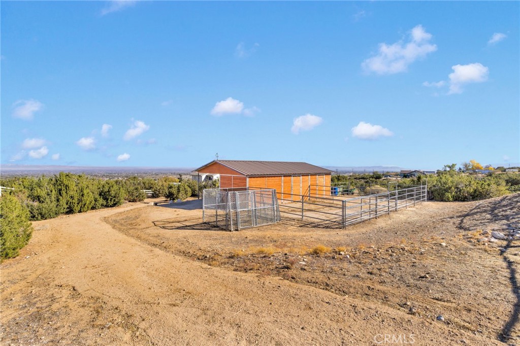 2909 Silver Ridge Drive Pinon Hills, CA 92372 - Photo 43 of 55 a view of a dry yard with a large trees