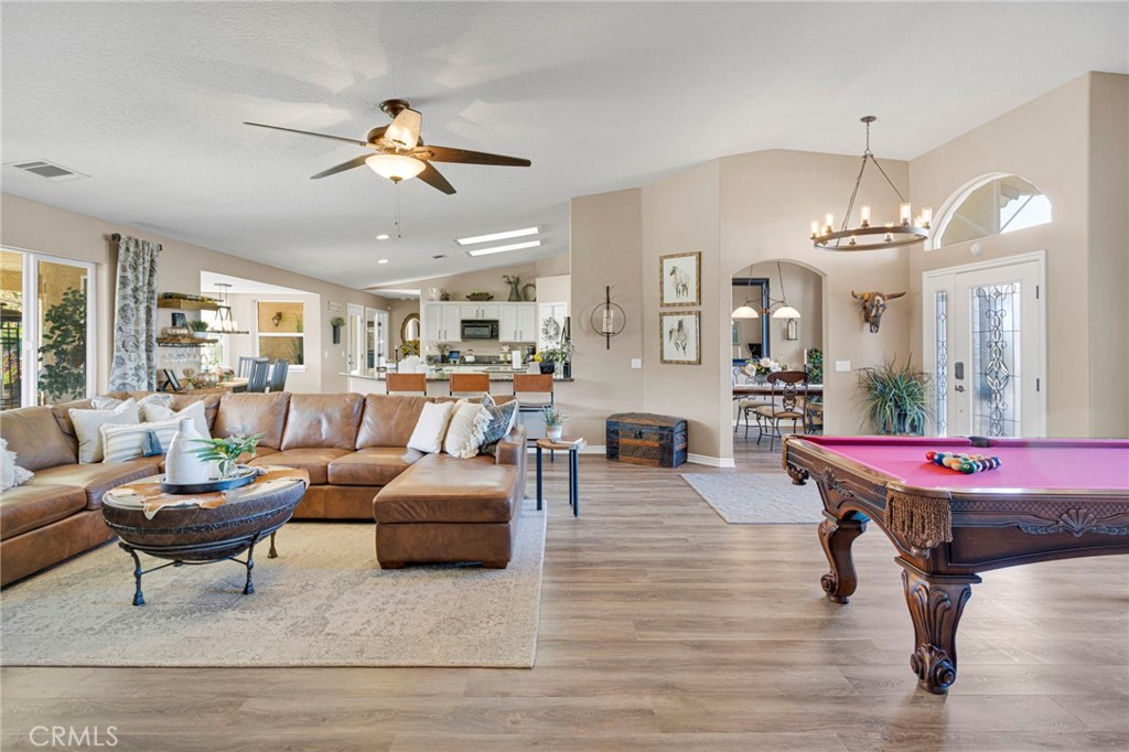 2909 Silver Ridge Drive Pinon Hills, CA 92372 - Photo 7 of 55 a living room with furniture kitchen view and a chandelier
