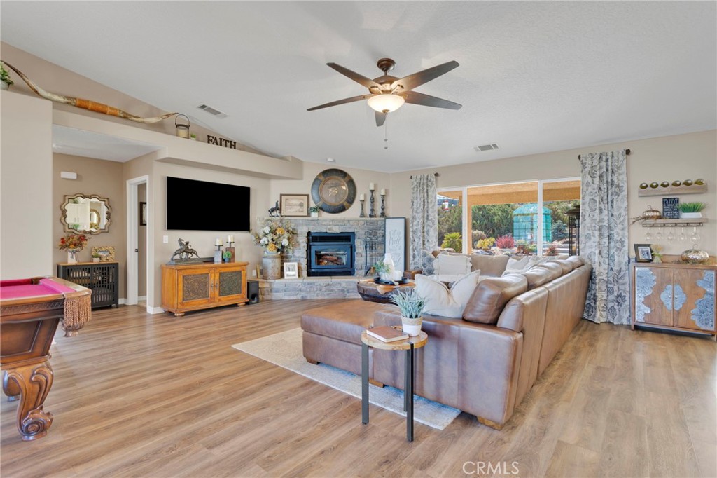 2909 Silver Ridge Drive Pinon Hills, CA 92372 - Photo 9 of 55 a living room with furniture a fireplace and a flat screen tv