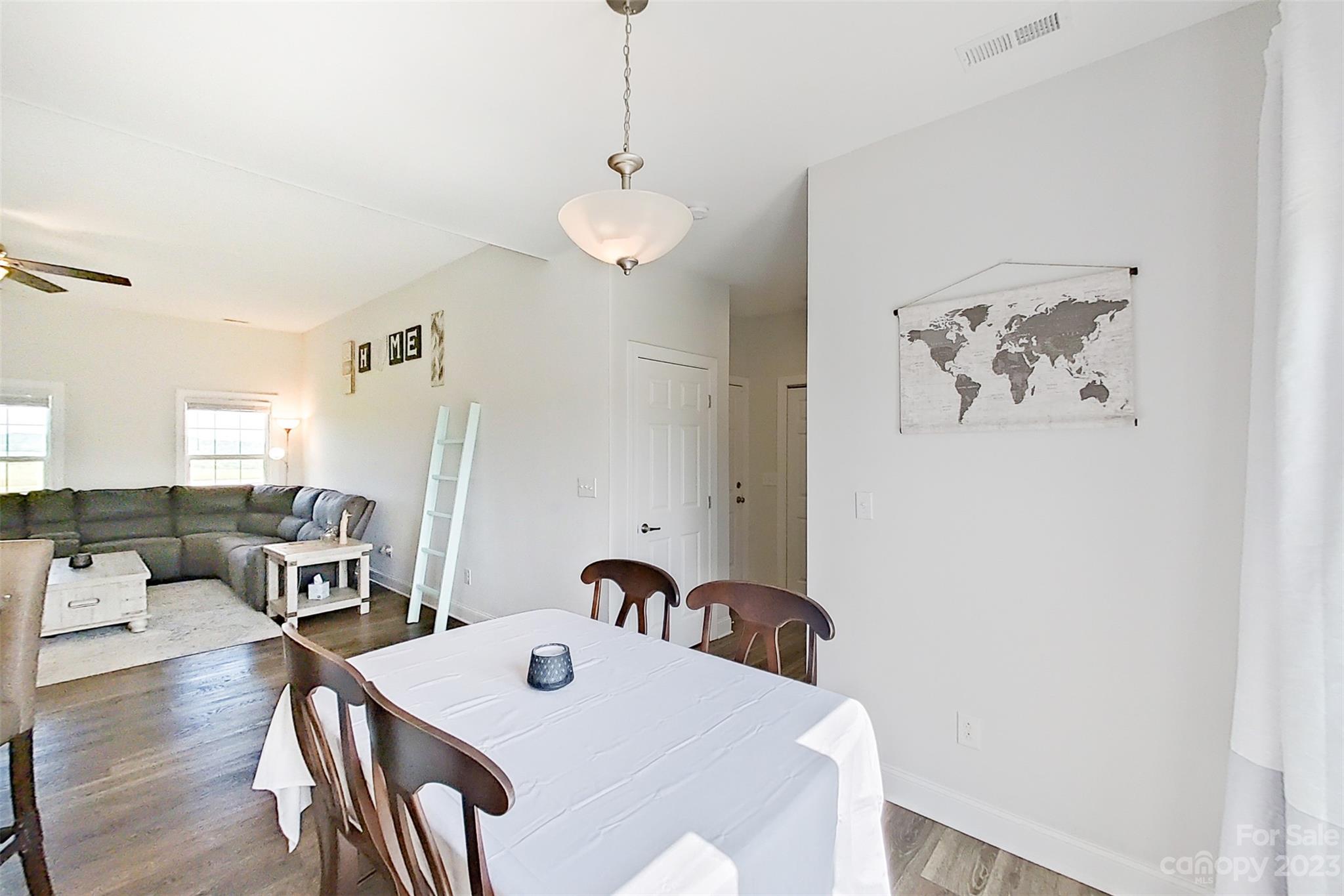 345 Rash Road Olin, NC 28660 - Photo 15 of 39 a view of a dining room and livingroom with furniture wooden floor a chandelier