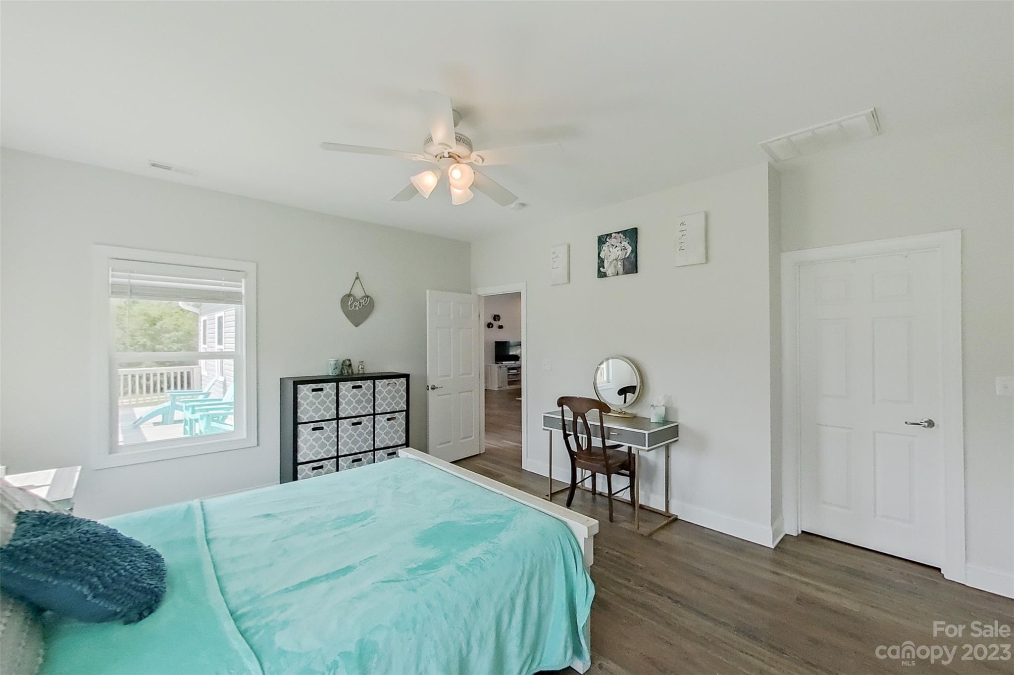 345 Rash Road Olin, NC 28660 - Photo 17 of 39 a bedroom with a bed and a window with chair