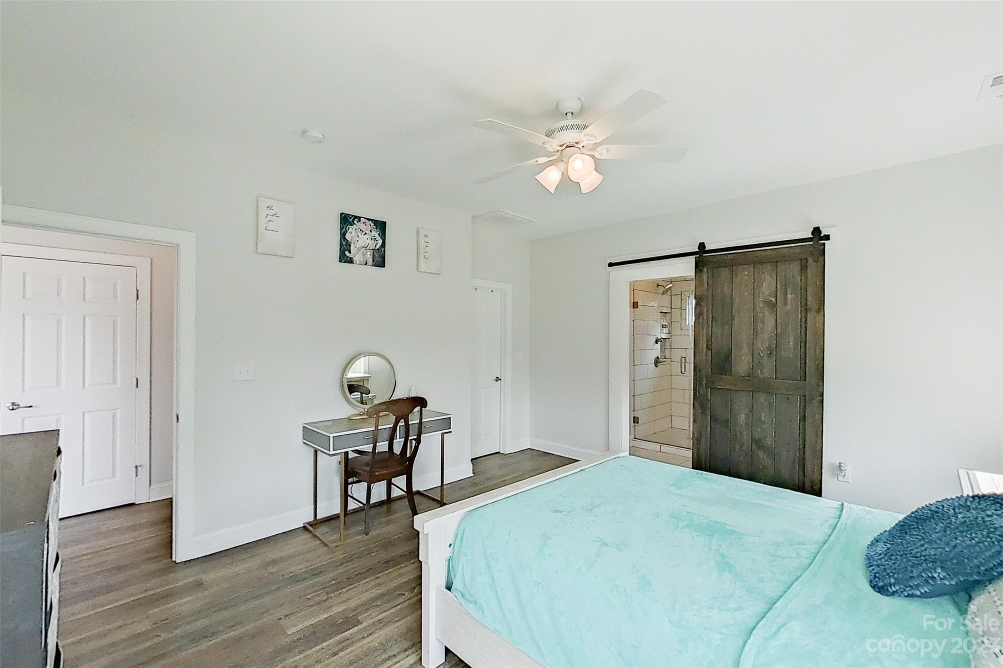 345 Rash Road Olin, NC 28660 - Photo 18 of 39 a bedroom with a bed and a chandelier