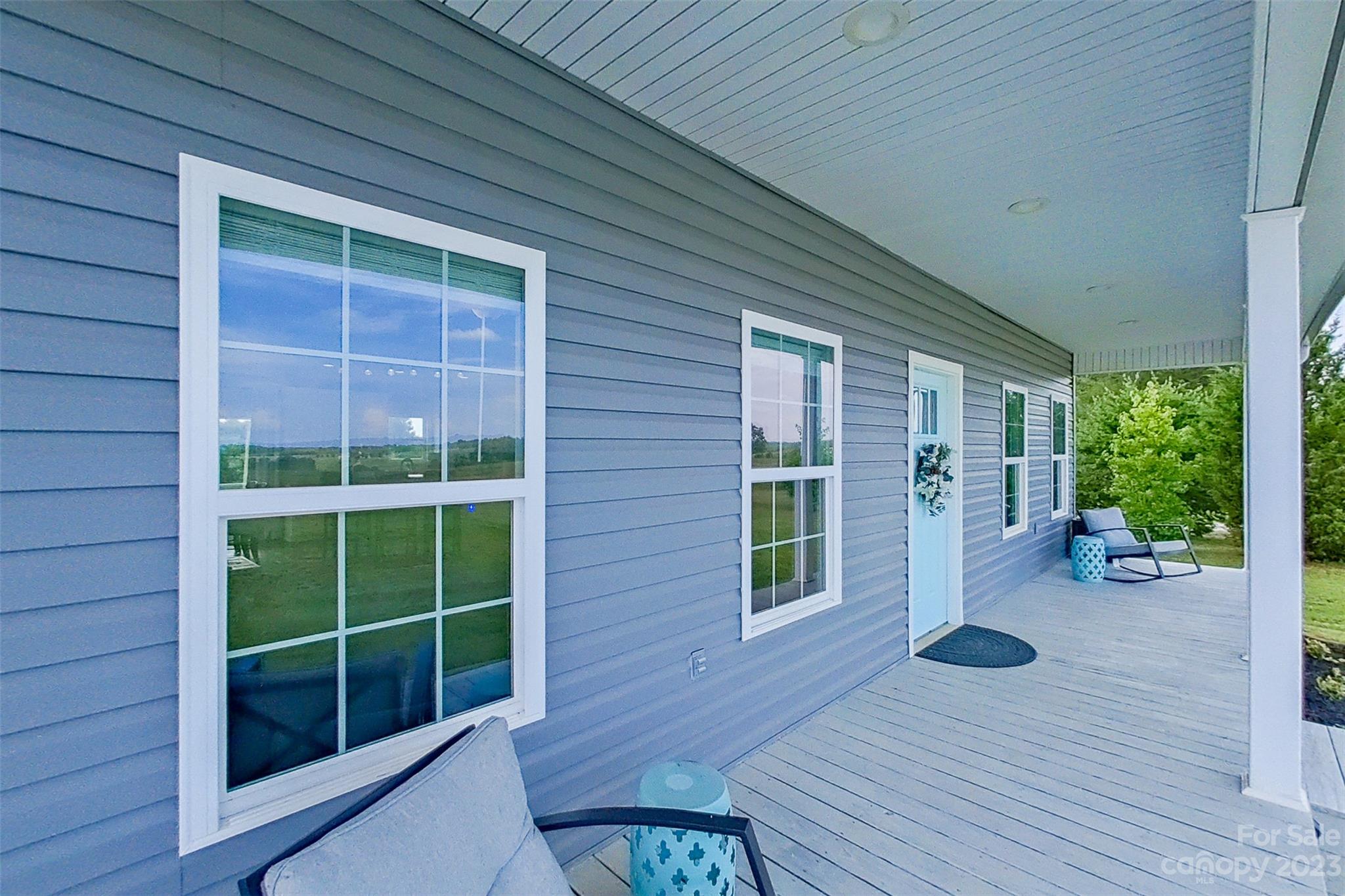 345 Rash Road Olin, NC 28660 - Photo 2 of 39 a view of a deck with wooden floor and garden