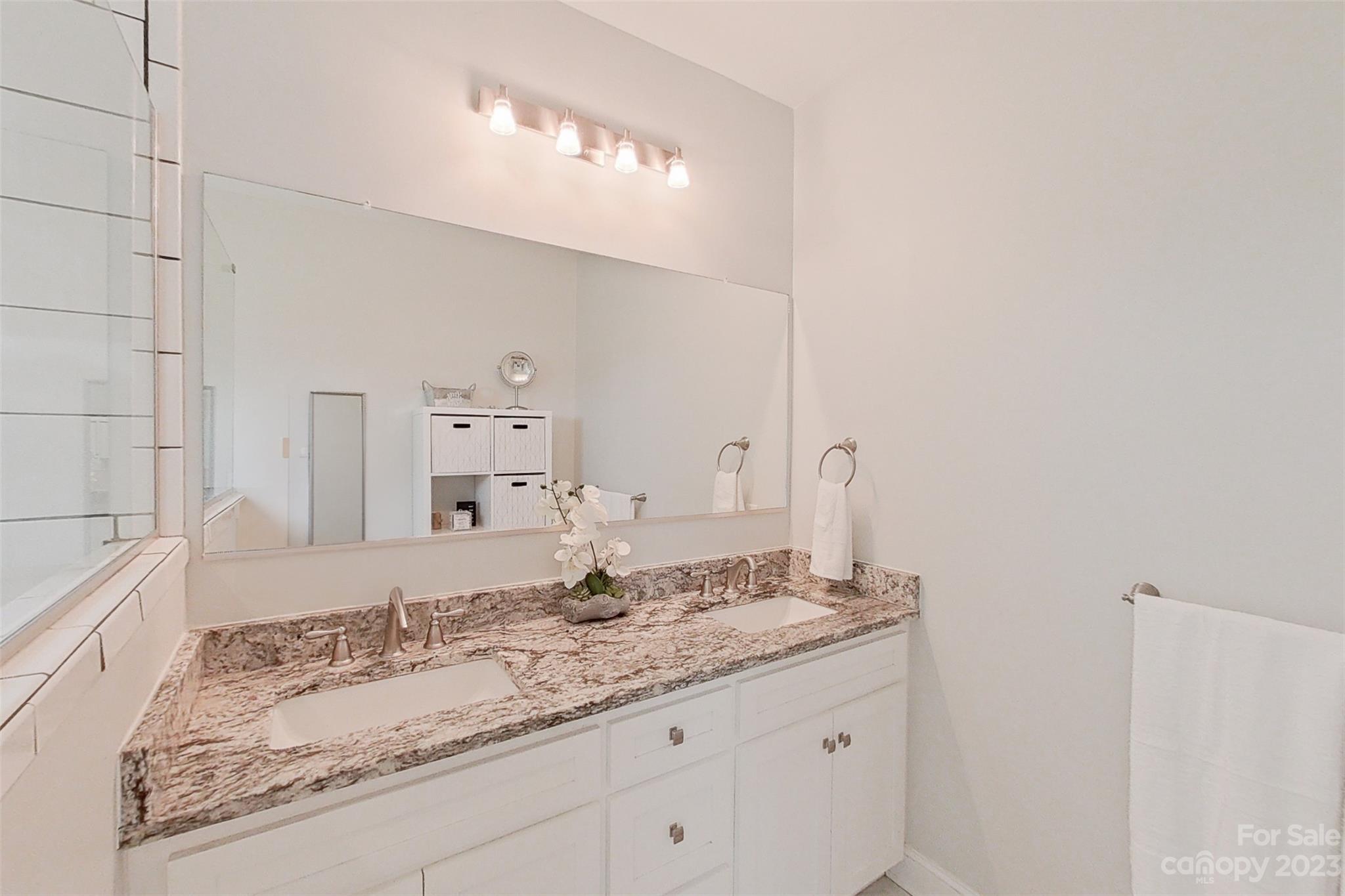 345 Rash Road Olin, NC 28660 - Photo 21 of 39 a bathroom with a granite countertop sink and a mirror