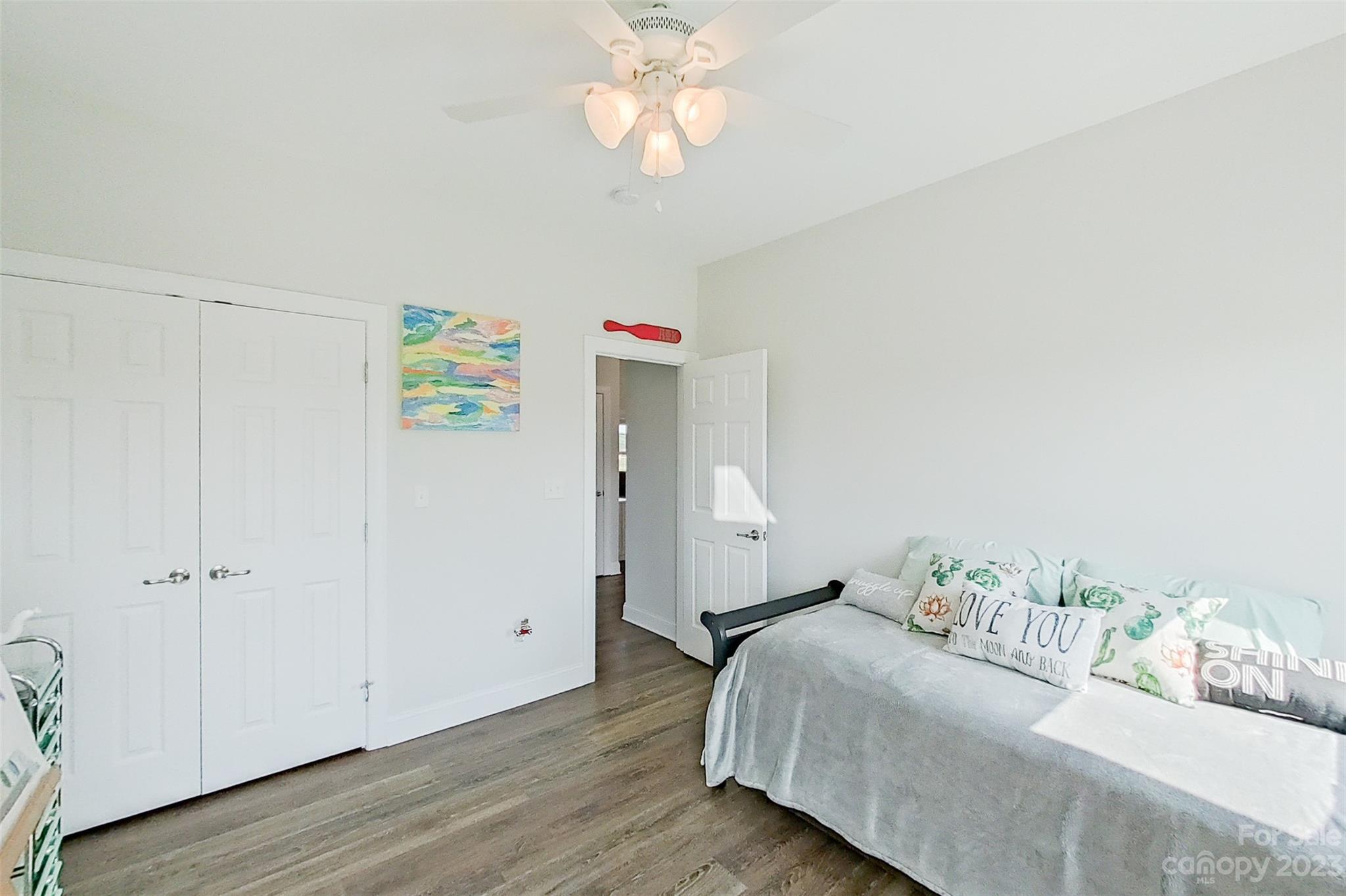 345 Rash Road Olin, NC 28660 - Photo 24 of 39 a bedroom with a bed and a chandelier